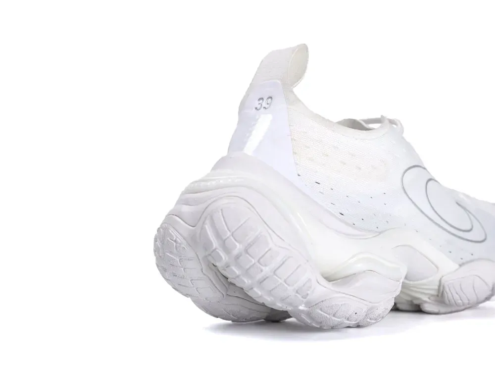 White shoe featuring a mesh upper and rubber sole for enhanced grip and comfort.