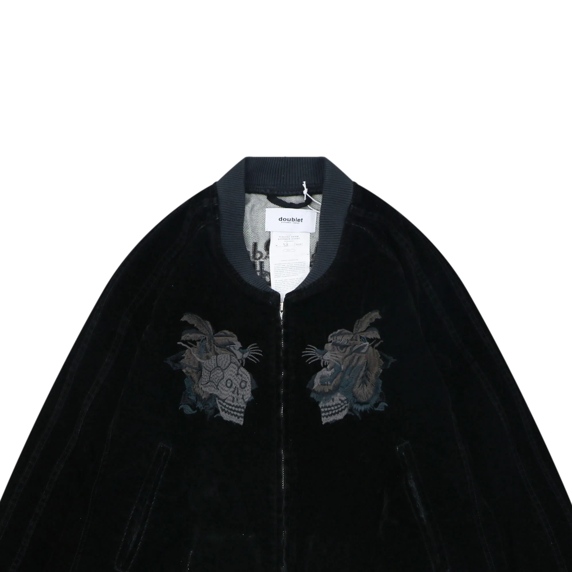 Black velvet jacket with a ribbed collar and embroidered animal design on chest.