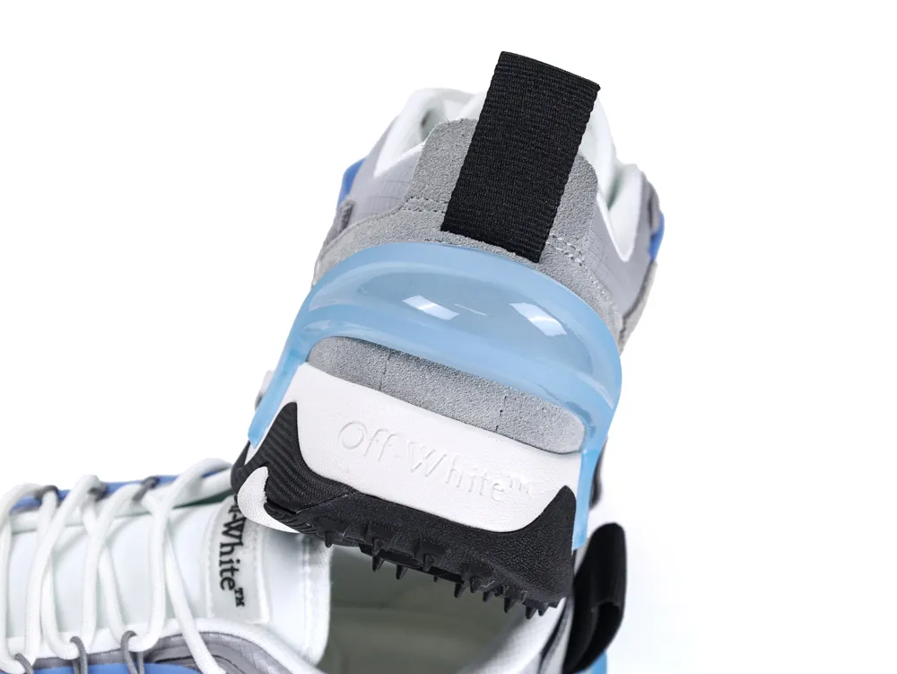 Gray and blue sneaker with suede material and black pull tab at the heel.