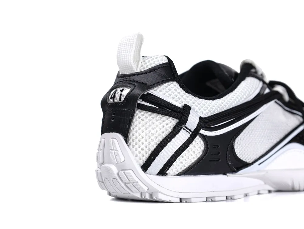Black and white mesh sneaker with rubber sole, featuring heel and side details.