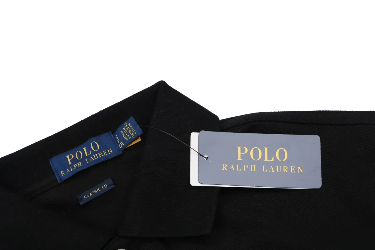 Black cotton polo shirt collar with blue and gold tags attached.