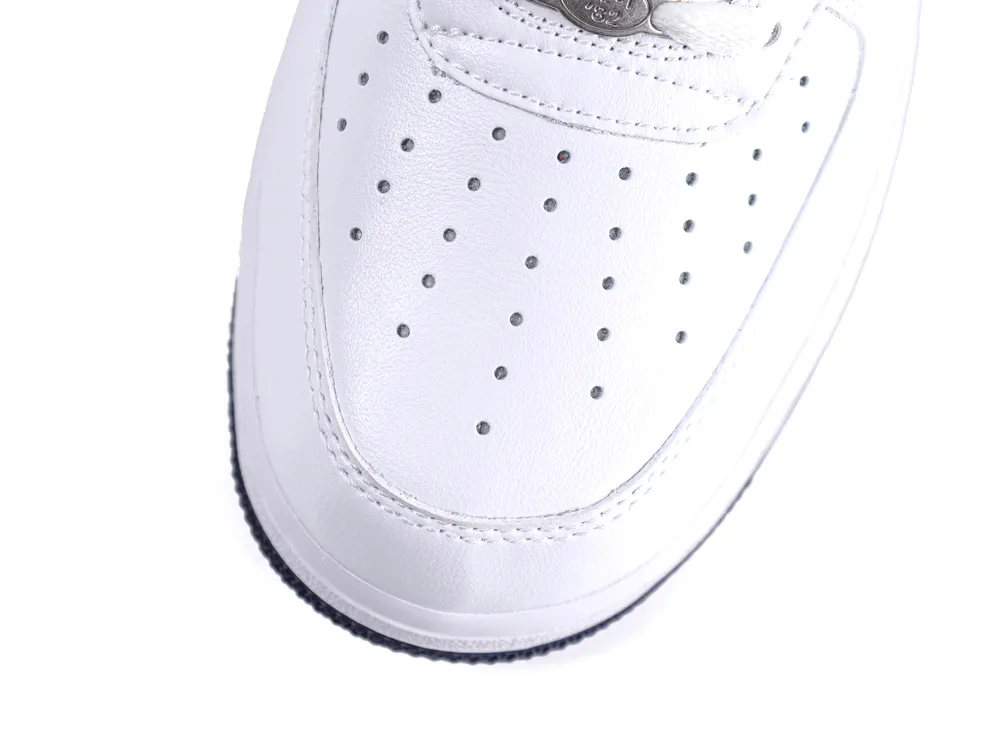 White leather sneaker's toe with perforations and lace detail visible.