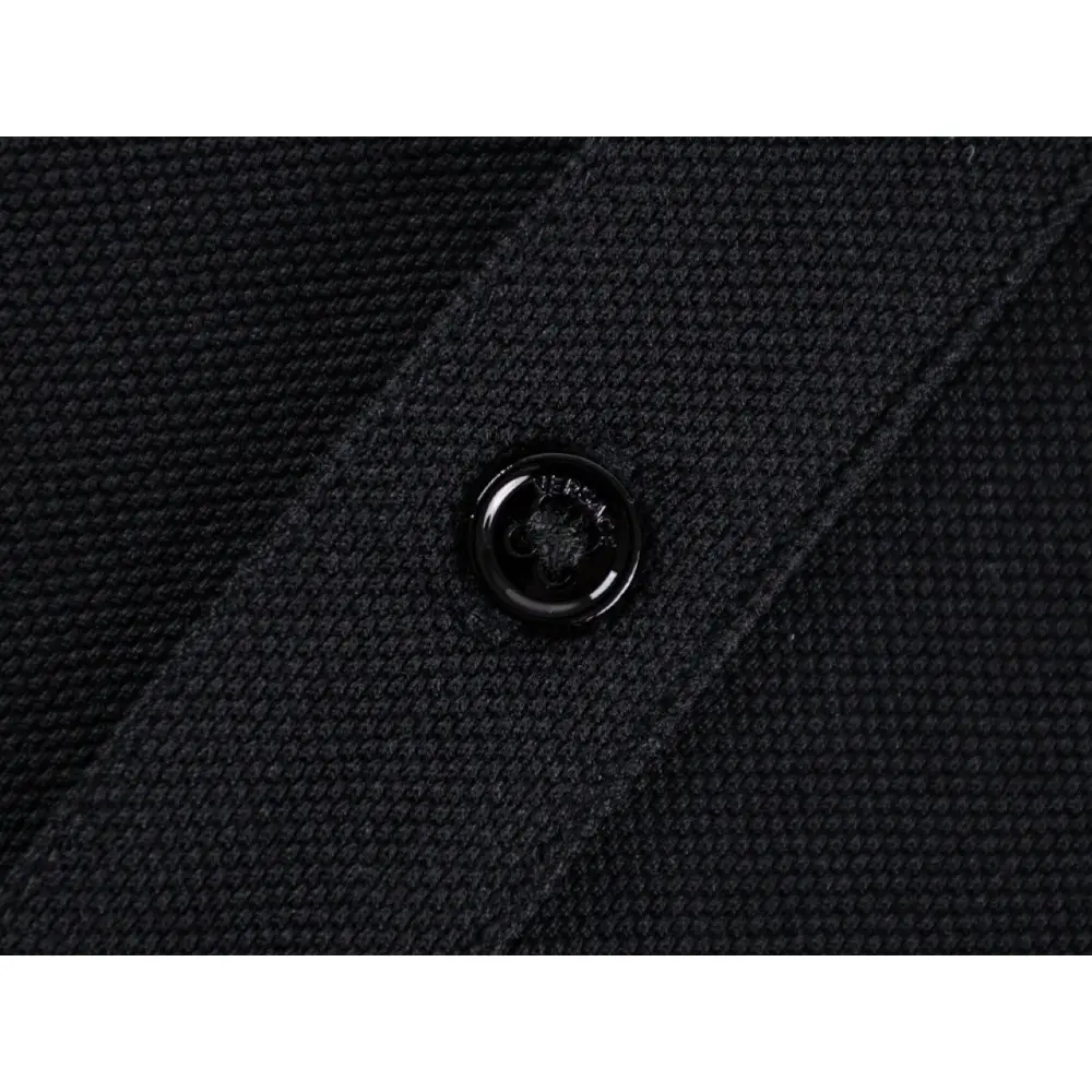 Close-up of button detail on the garment