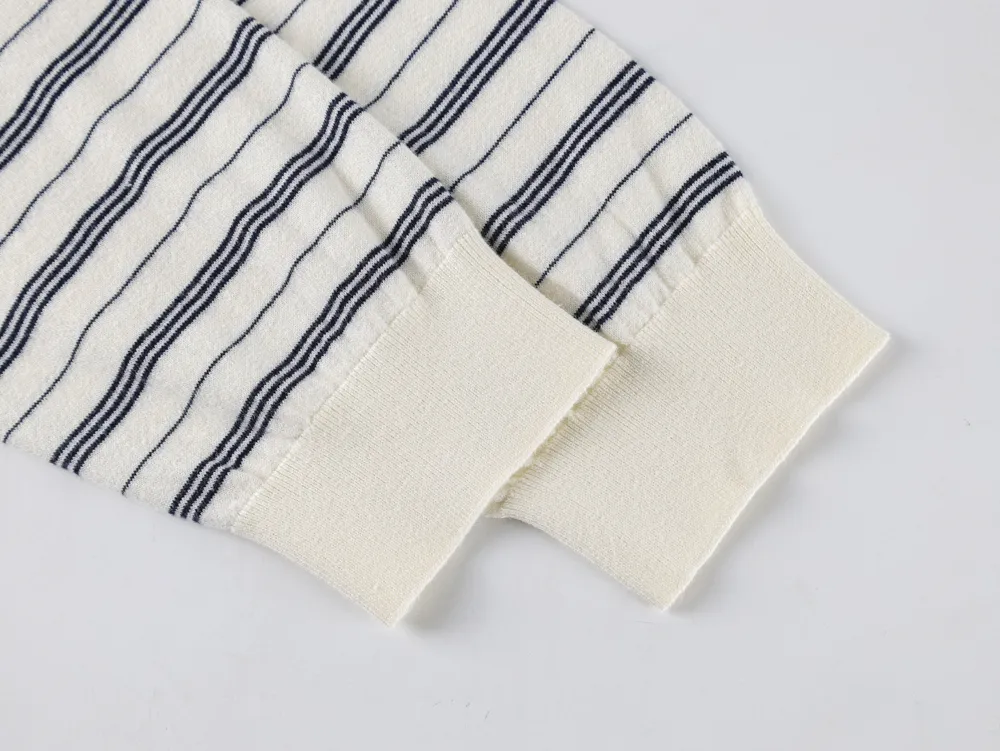 White and navy striped fabric with ribbed cuffs, likely cotton material.