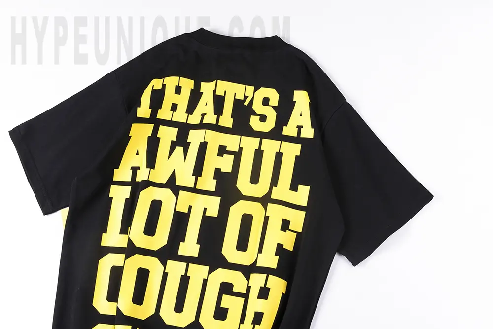 Close-up rear view of the black That’s A Awful Lot of Cough Syrup Bear Dropout T-shirt, showcasing the brand text in rubberized print.