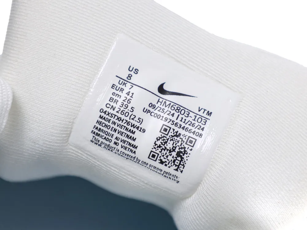 Close-up of a white fabric interior label inside a shoe.