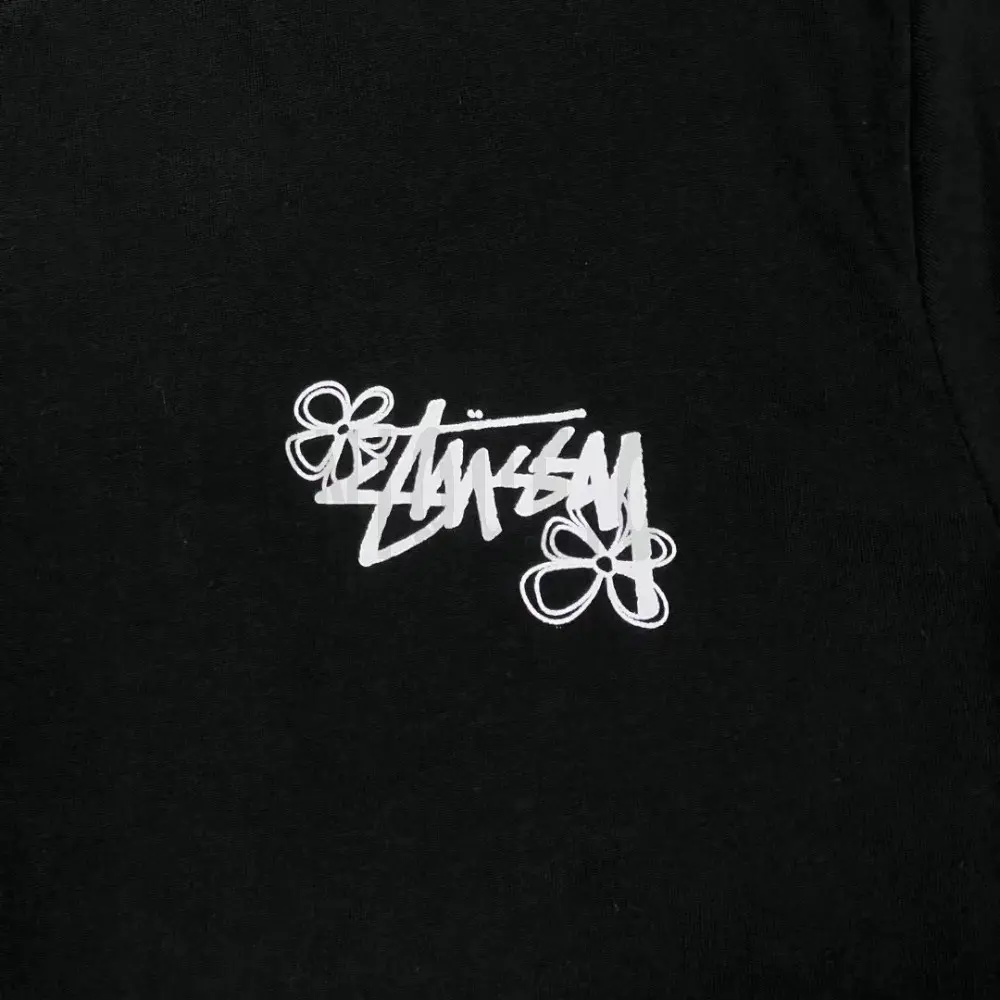 Detailed shot capturing the graphic print on the black tee's front panel.