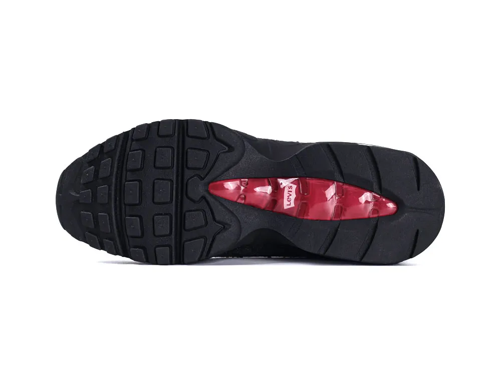 Black rubber shoe sole with red accents, featuring a branded logo.