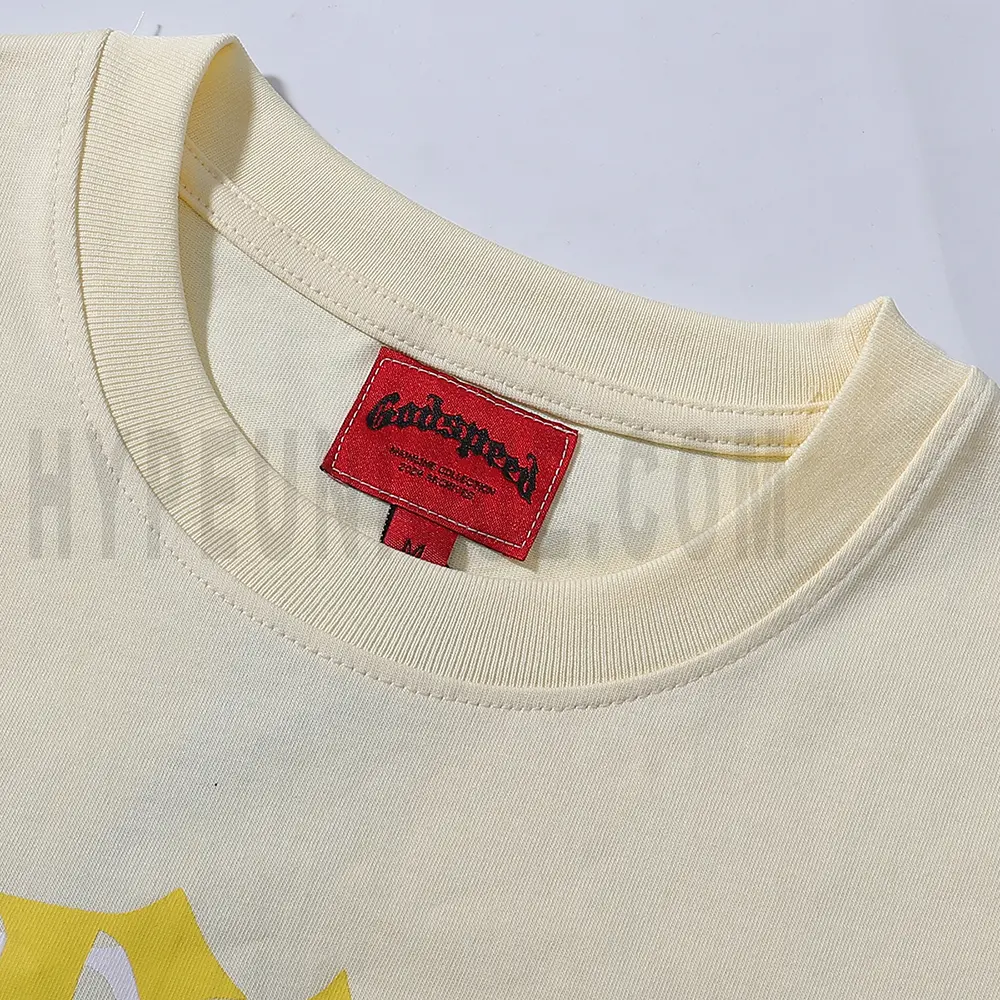 Detailed close-up of the tee's neck label, featuring wash care instructions and subtle brand branding in a clean, minimalist typography