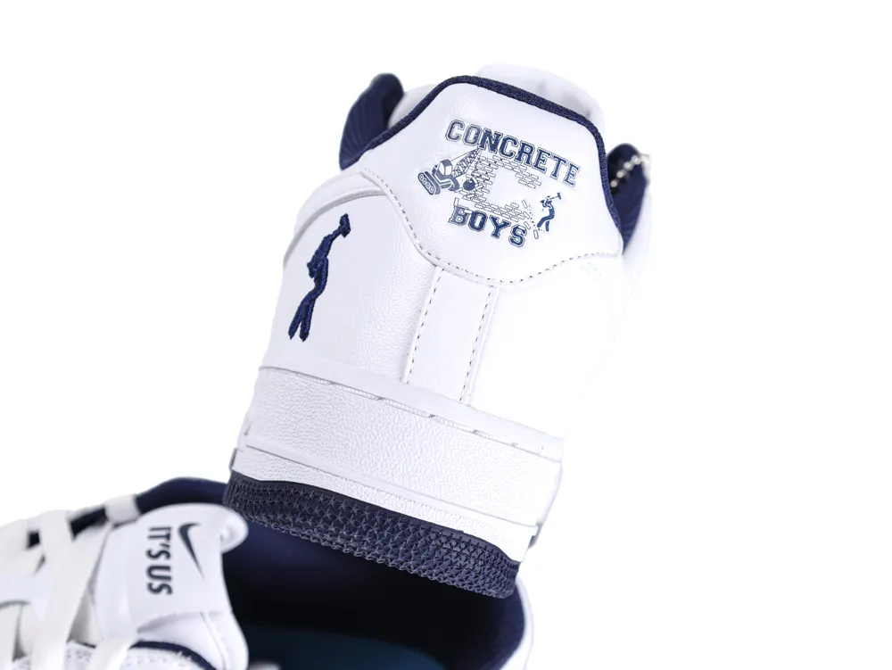White leather sneaker with navy accents and "Concrete Boys" design on the heel.