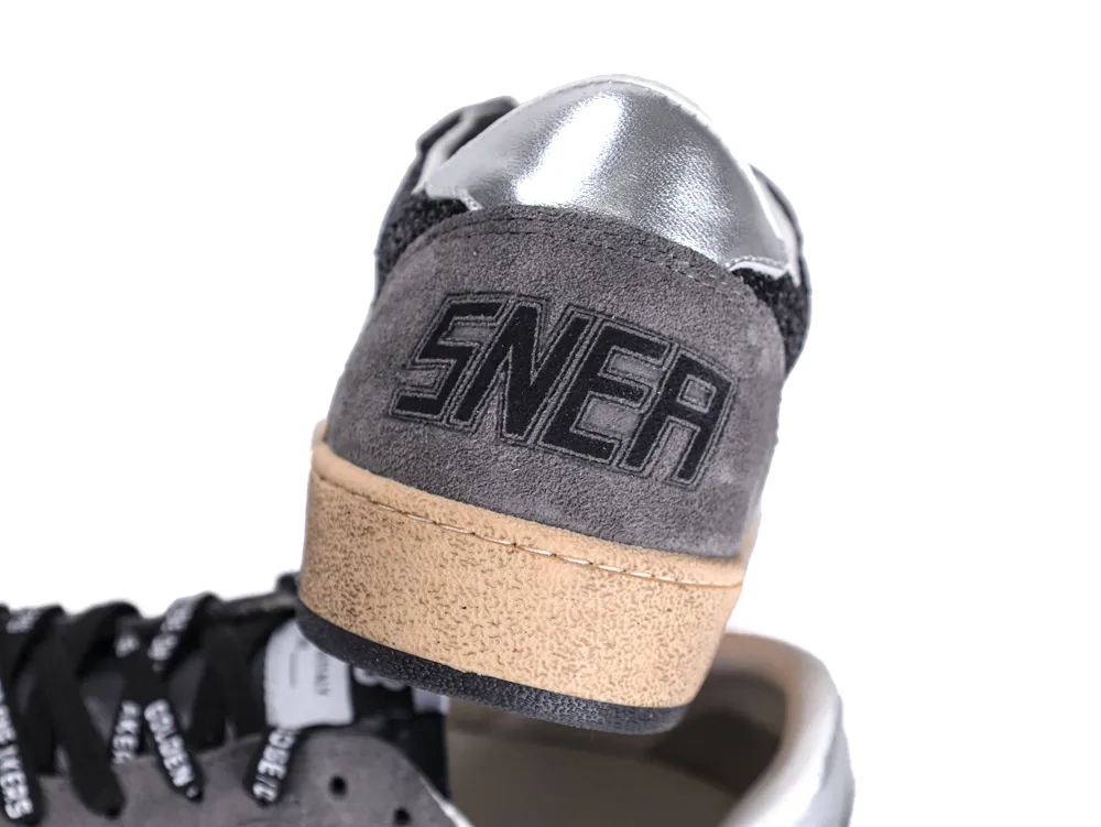 Close-up of grey suede heel tab with embossed branding on Golden Goose sneaker.