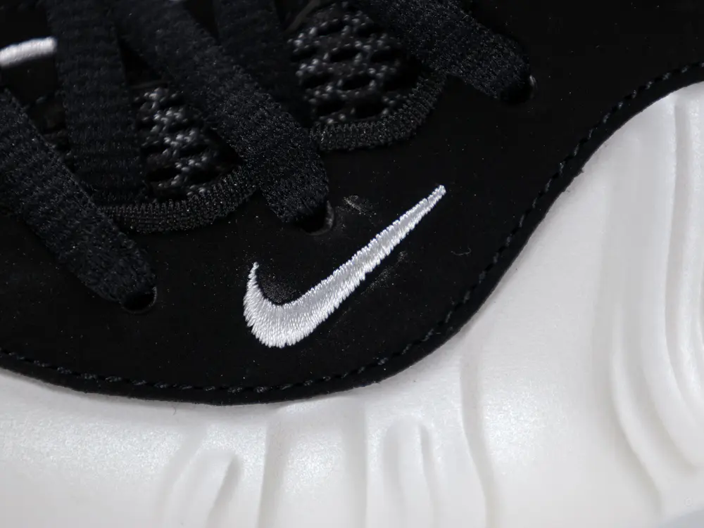 White embroidered swoosh