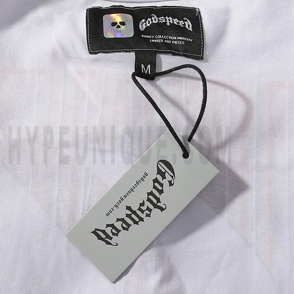 Close-up of the tee's featuring wash care instructions and subtle brand branding in a clean, minimalist typography