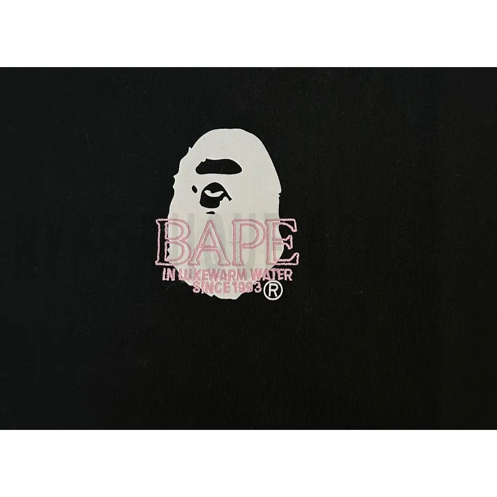 Detailed shot capturing the graphic print on the black tee's front panel.