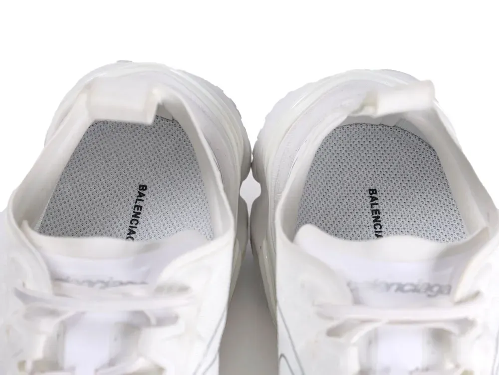 White fabric sneakers with visible insoles and branding text. Top view.