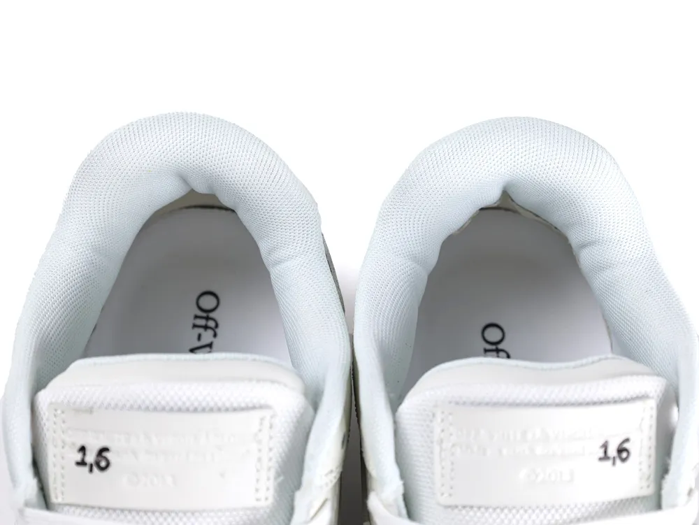White mesh sneaker tongues with printed text and cushioned collars visible inside.