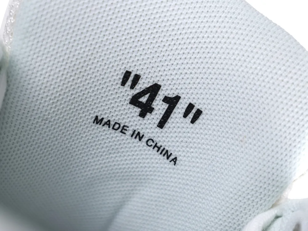 Close-up of white fabric shoe interior with size "41" and "MADE IN CHINA".