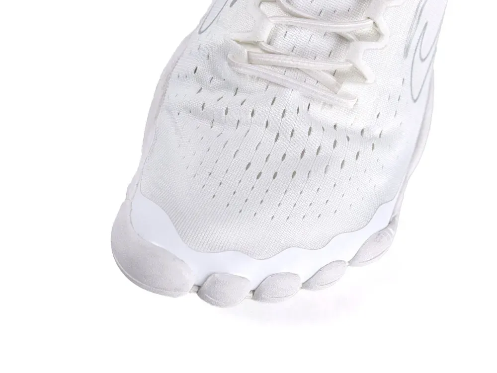 Close-up of a white sneaker toe, mesh material, with visible perforations.