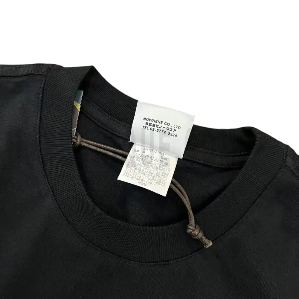 Neckline tag close-up, displaying garment care symbols and brand information with fashion-forward presentation.