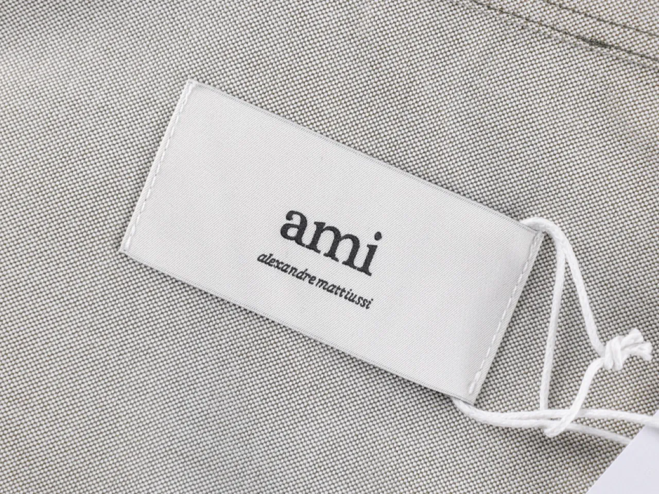 Label on a textured gray material with attached white string.