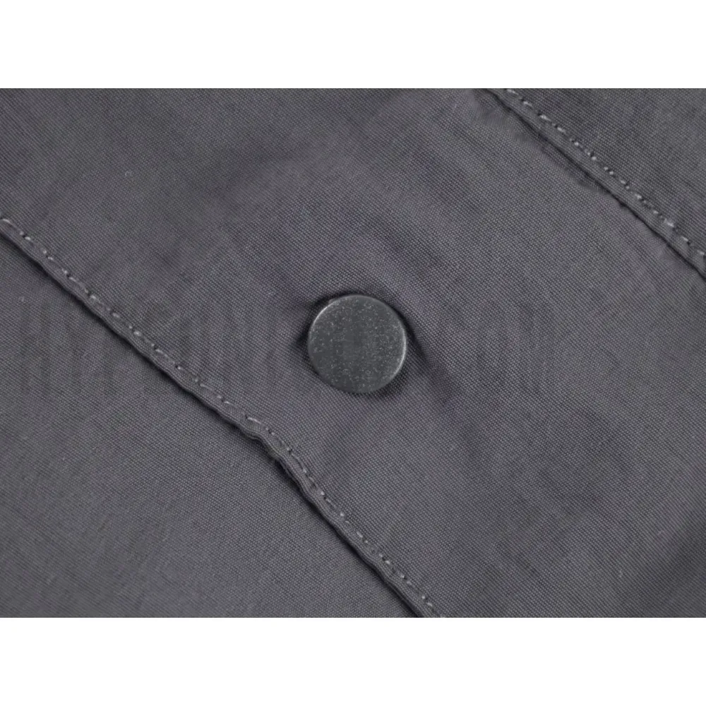 Close-up of button detail on the pants
