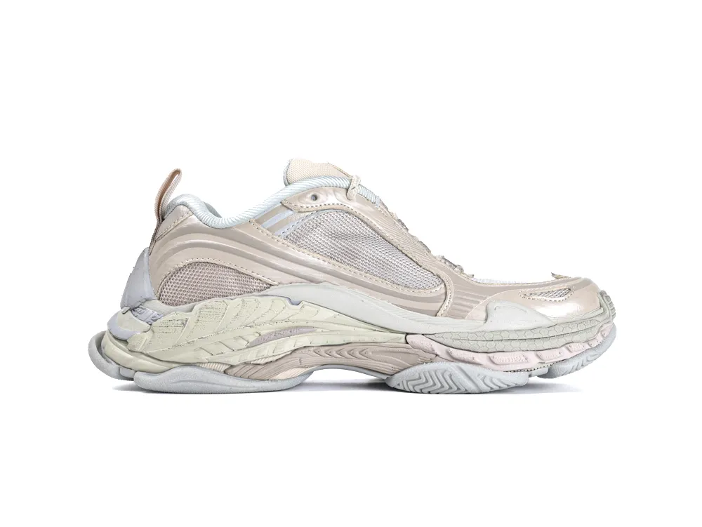 Beige sneaker with a mesh and leather upper, featuring a textured rubber sole.