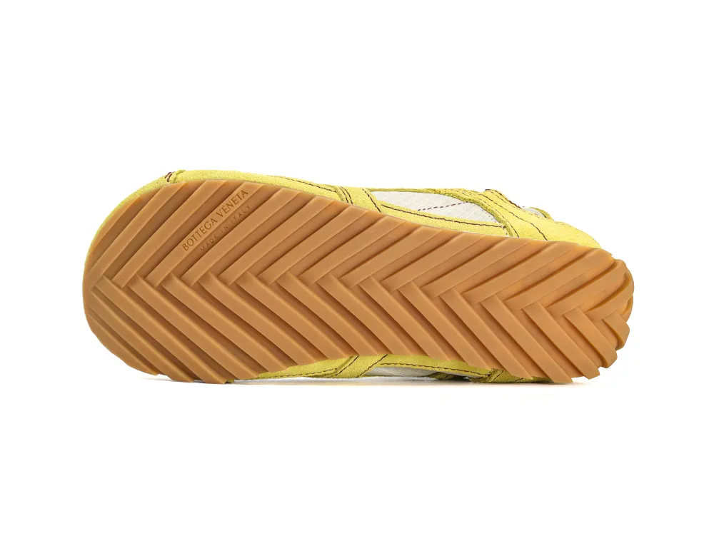 Yellow and tan rubber sole with zigzag pattern, part of a shoe.