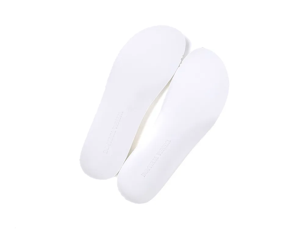 White rubber shoe insoles, designed for comfort and support, top view.