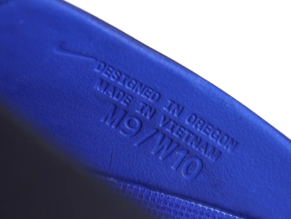 Close-up of the inner side wall embossed with "DESIGNED IN OREGON," "MADE IN VIETNAM," and size "M9/W10."