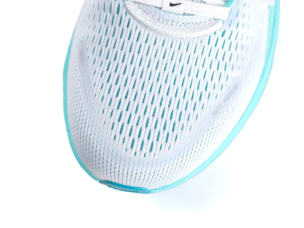 White mesh sneaker with teal accents, focusing on the breathable toe area.
