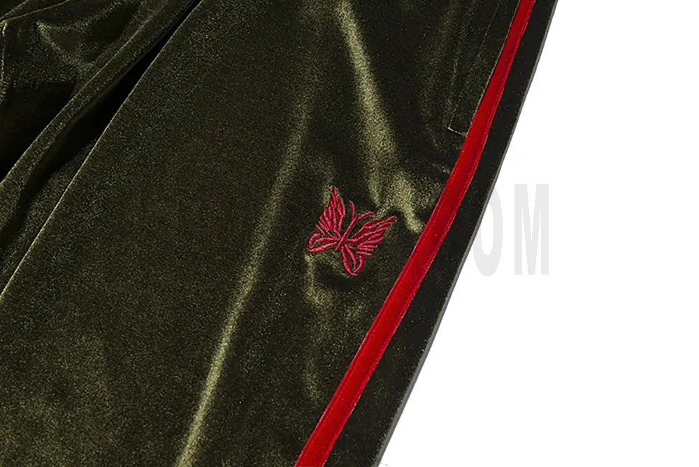 Exquisite red butterfly embroidery on a green base.