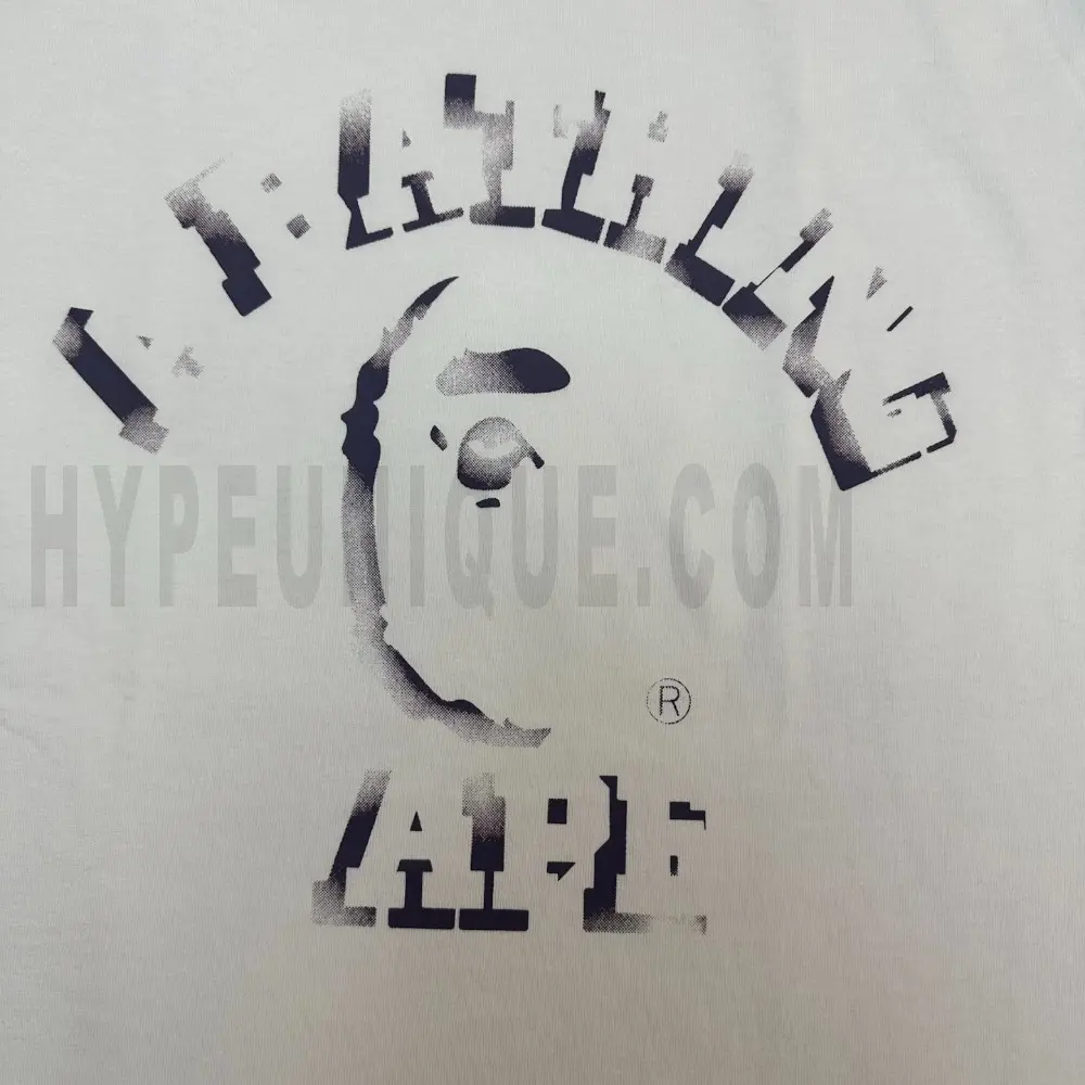 Detailed shot capturing the graphic print on the white tee's front panel.