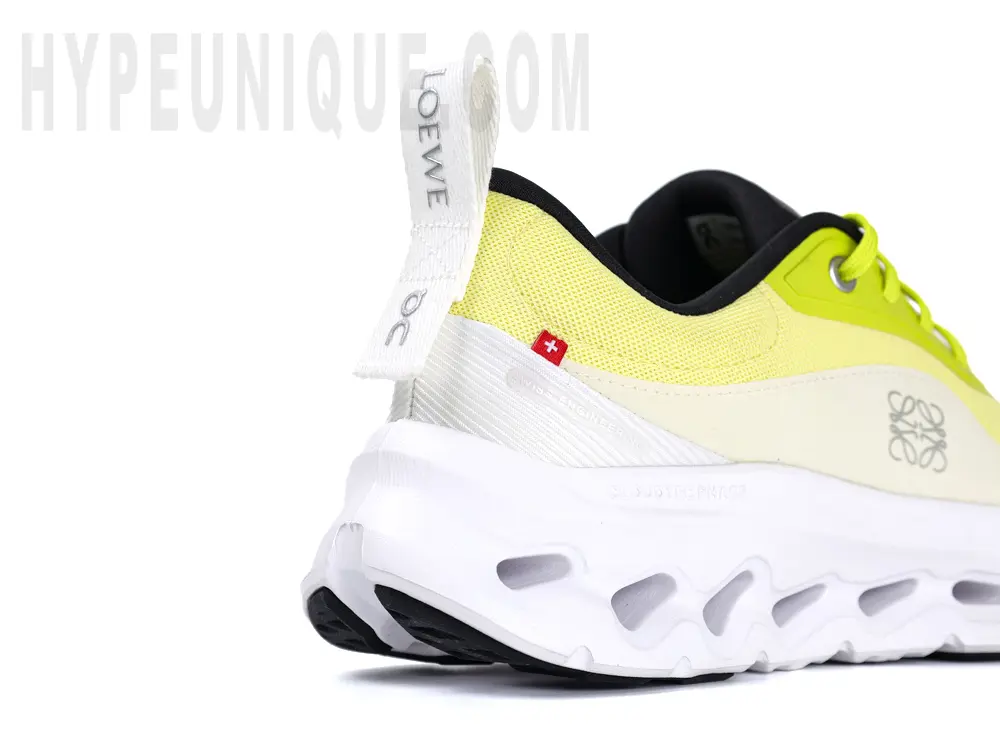 A close-up of the right rear heel of the On Cloudtilt Loe 2 WMNS Neon Yellow / White shoe.