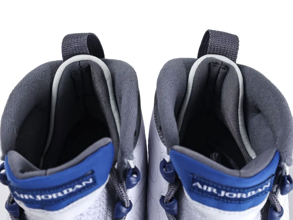 Close-up of white and blue sneakers, fabric material, focusing on tongue and collar.
