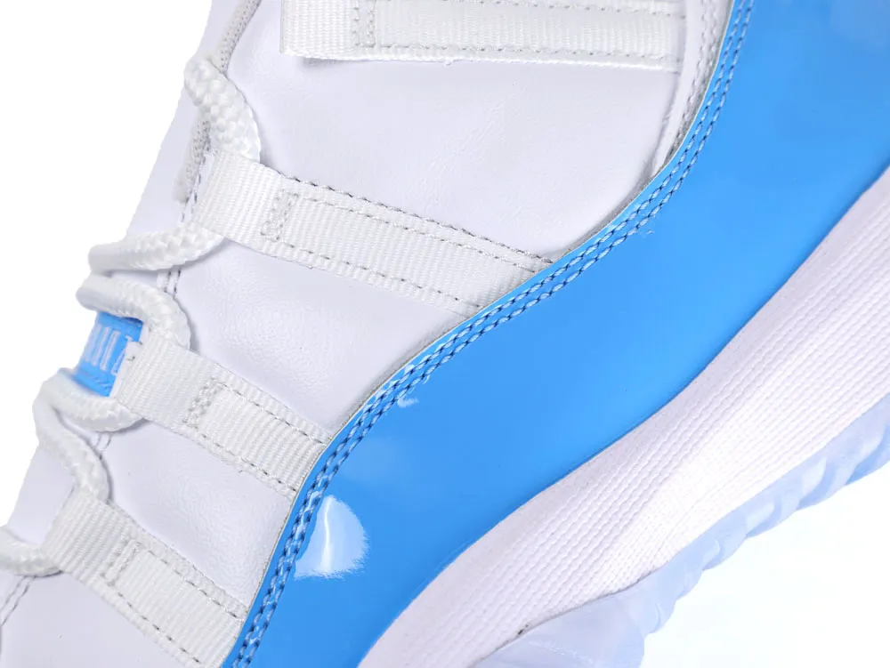 White and blue sneaker with glossy patent material and fabric lace loops.