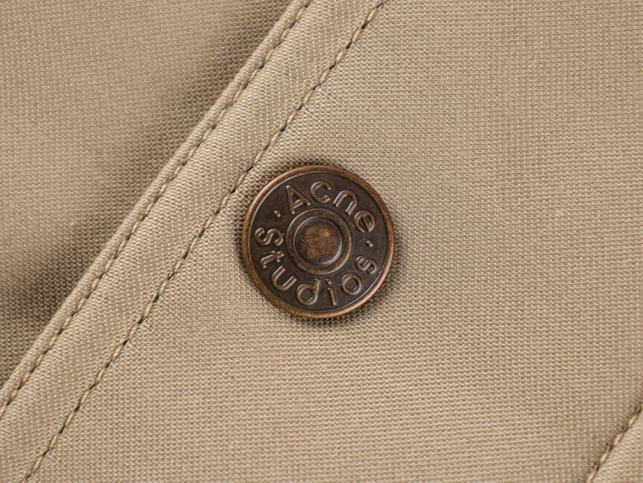 Beige fabric with metal button Detail