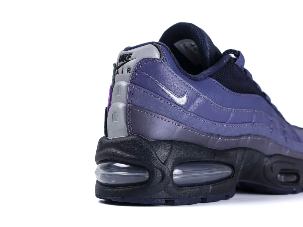 Purple sneaker with leather material, featuring a black sole and visible air bubble.