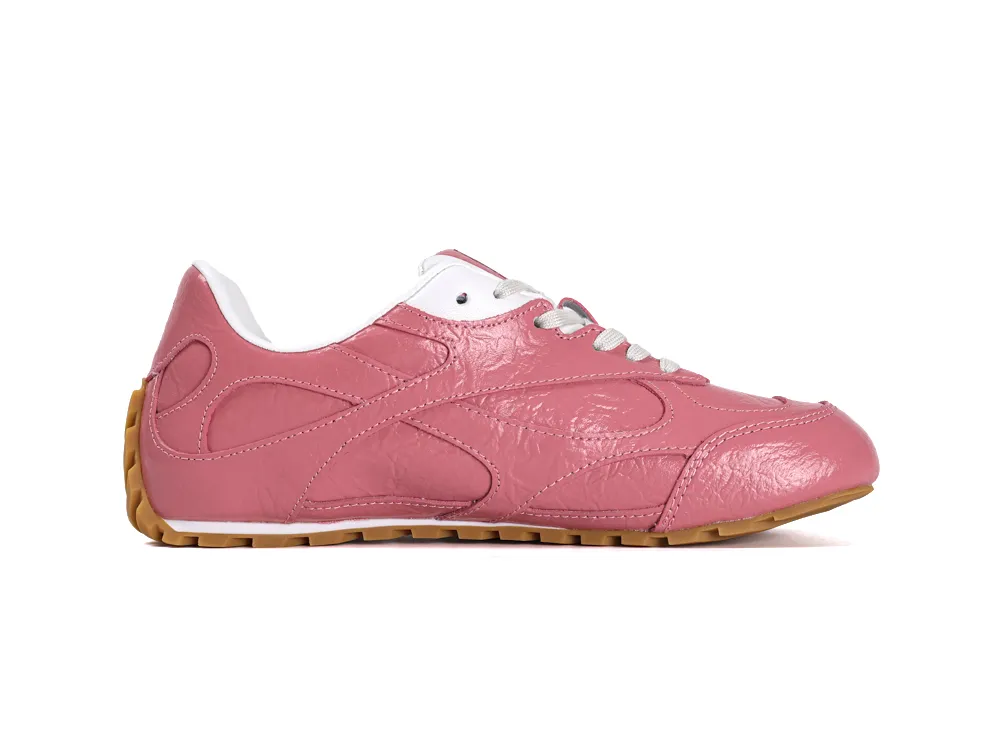 Side profile of the right Bottega Veneta Orbit Flash sneaker in Barolo pink leather with a gum outsole.