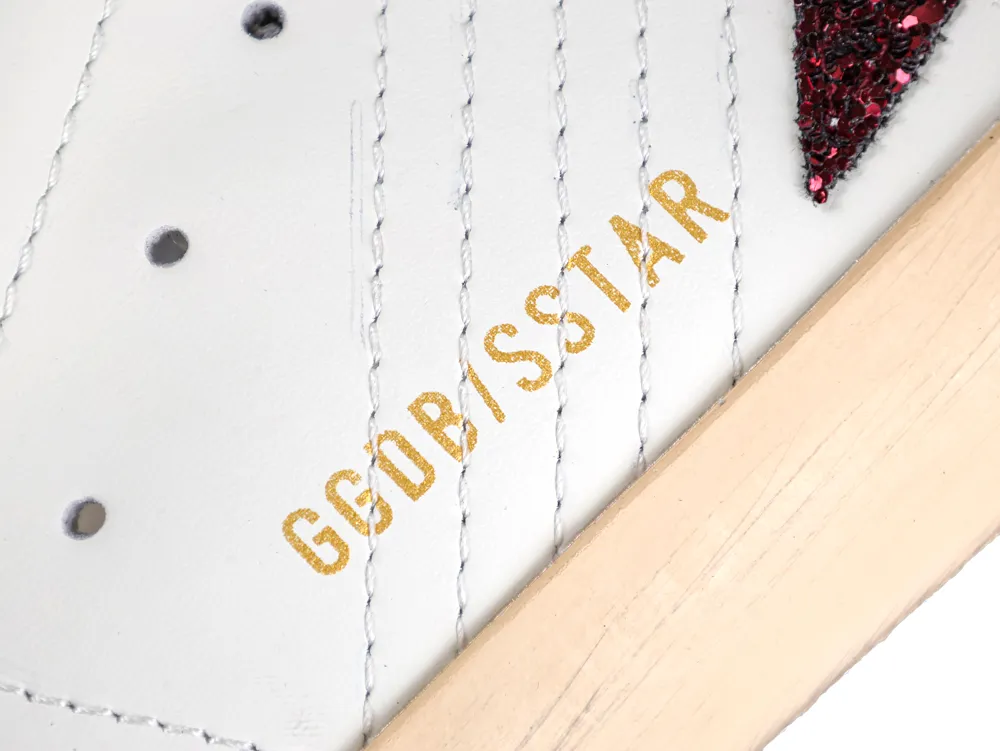 Gold GGDB/SSTAR branding on white leather sneaker with burgundy glitter