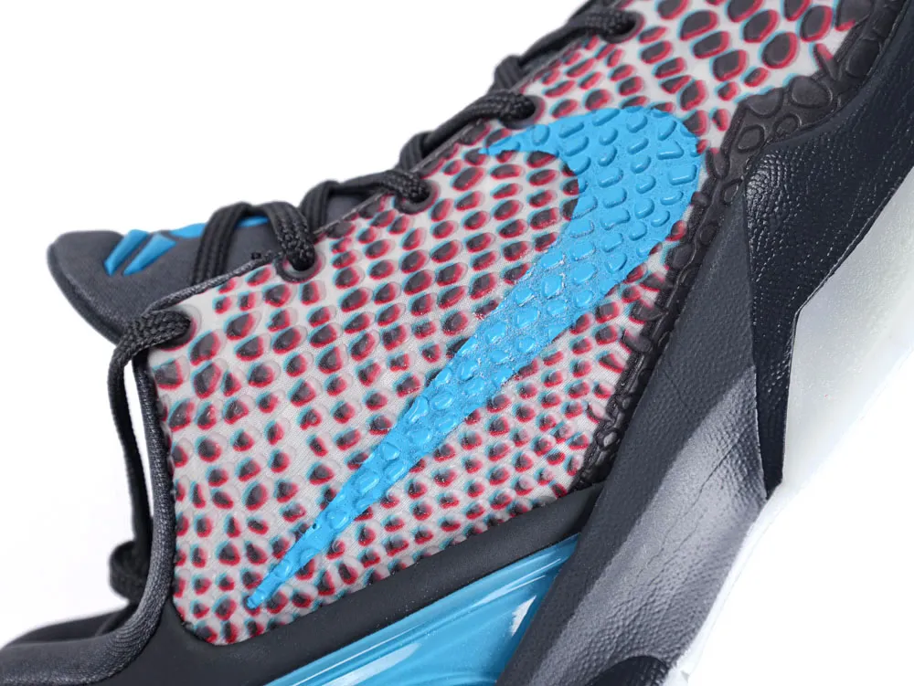 Close-up of sneaker with blue logo, textured fabric, and black laces.
