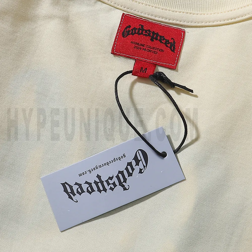 Close-up of the tee's featuring wash care instructions and subtle brand branding in a clean, minimalist typography