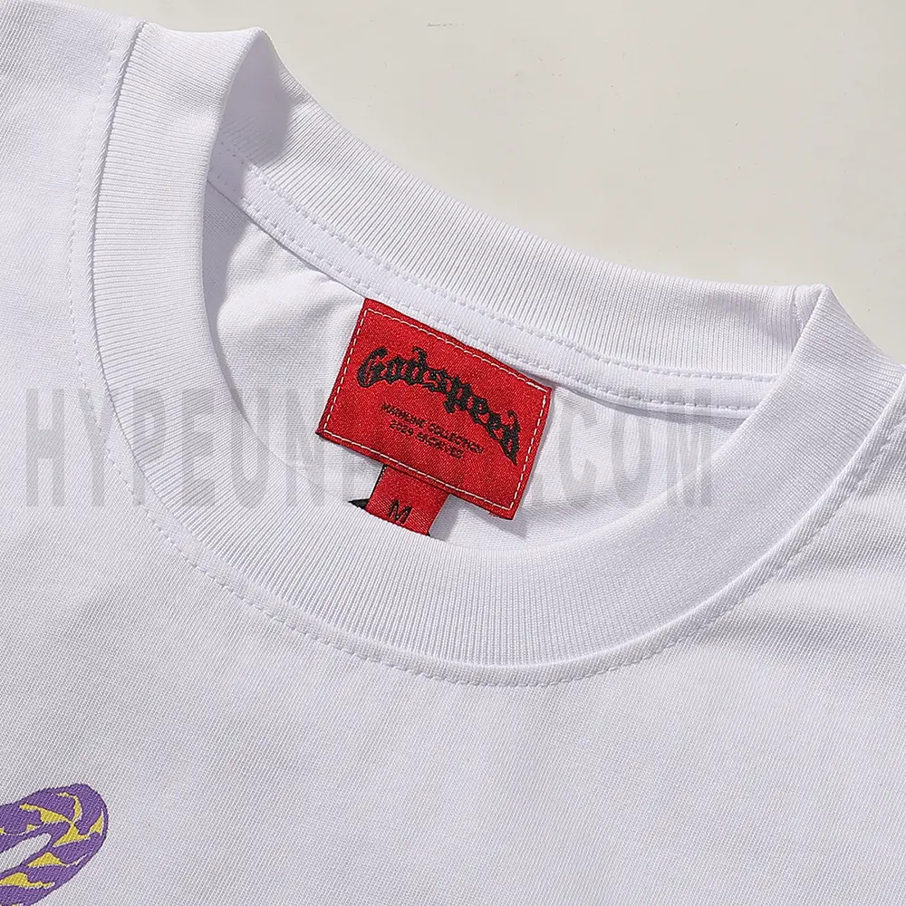 Close-up of the T-shirt's neckline tag, showcasing wash care instructions and brand details in a fashion design.