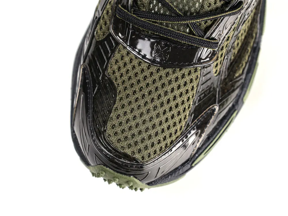 Close-up of mesh toe box and glossy overlay on Off-White Black Be Right Back sneaker