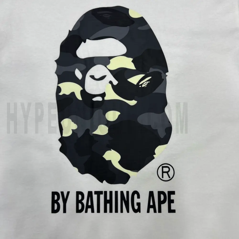 Detailed shot capturing the graphic print on the white tee's front panel.