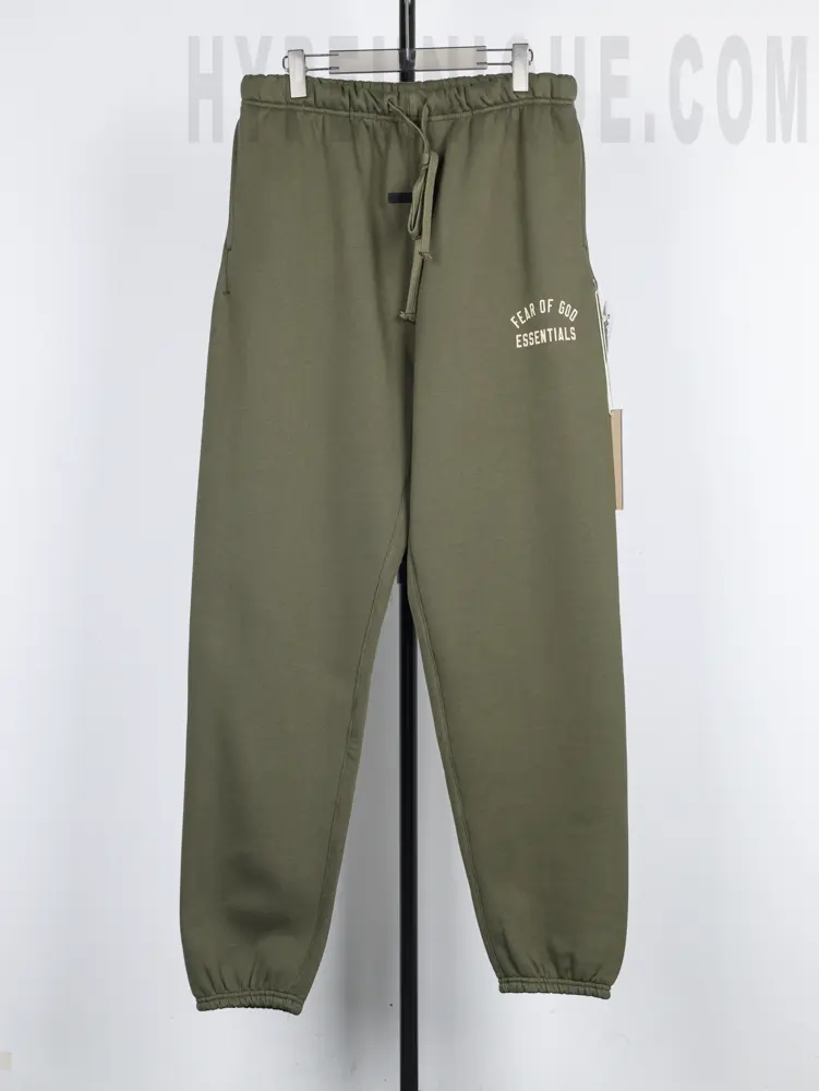 the green Fear of God Essentials Heavy Fleece Sweatpant