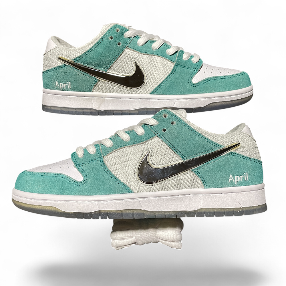 Mint and white sneakers with suede and mesh textures, featuring a metallic swoosh and "April" text, positioned in profile.