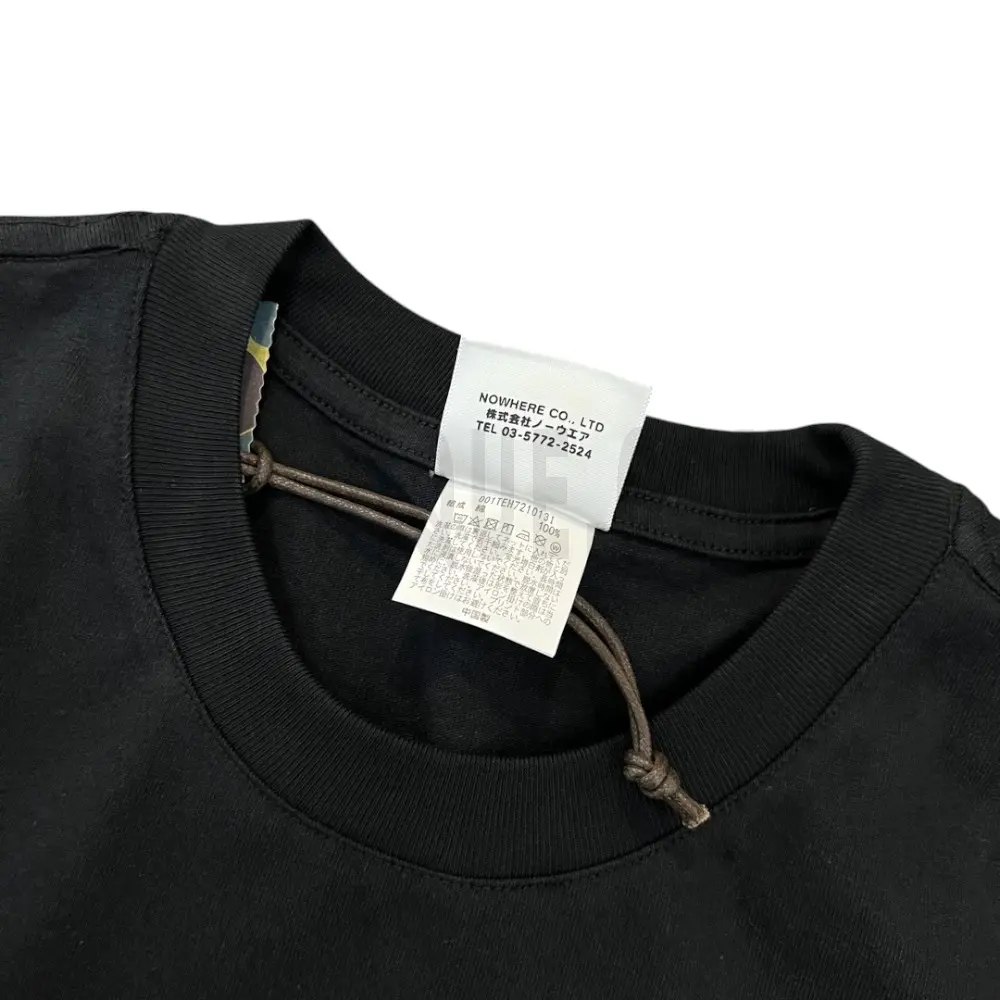 Neckline tag close-up, displaying garment care symbols and brand information with fashion-forward presentation.