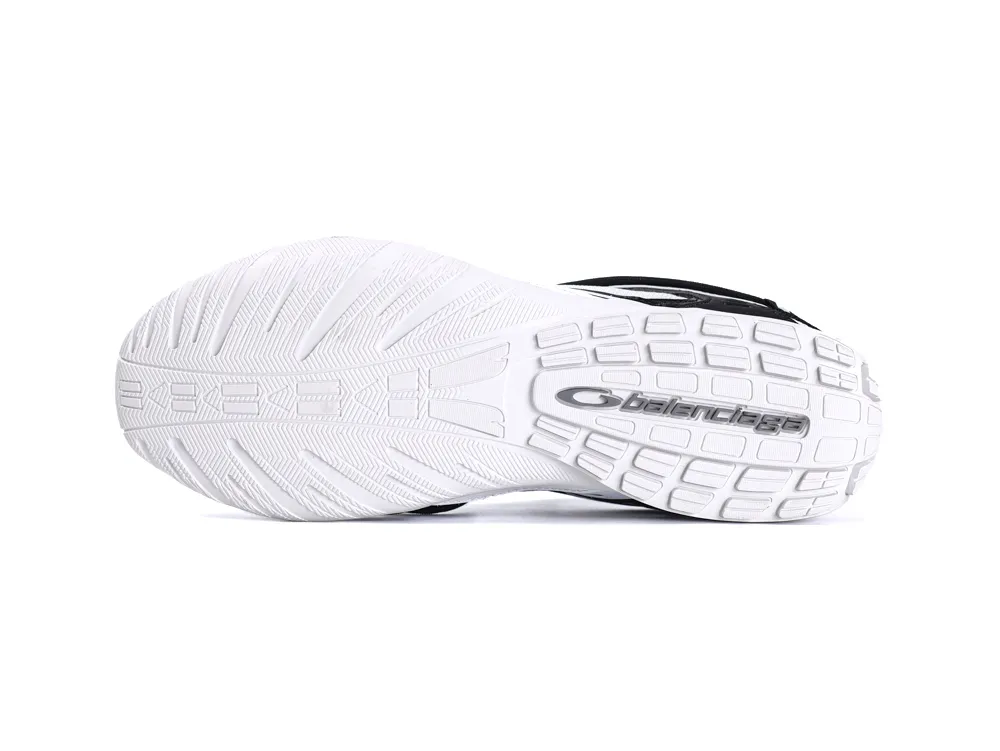 White rubber sole of a shoe with textured grip and logo detailing.