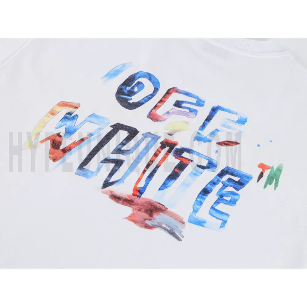 Detailed shot capturing the graphic print on the white tee's front panel.