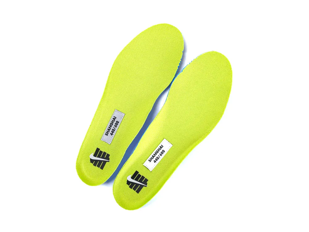 Bright yellow fabric insoles, with printed labels, feature textured material for comfort.